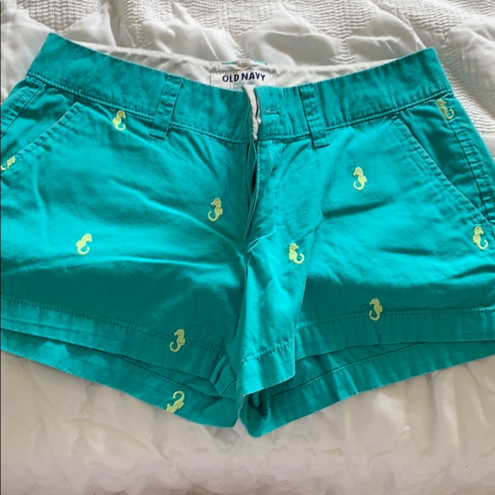 Green shorts with seahorses on them